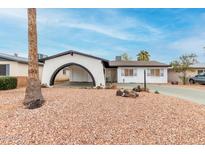 Charming home showcasing an arched entryway and minimalist landscaping at 4022 W Kaler Dr, Phoenix, AZ 85051