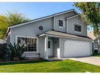 Charming two-story home with gray siding, white trim, and well-maintained landscaping at 5021 W Chicago N Cir, Chandler, AZ 85226