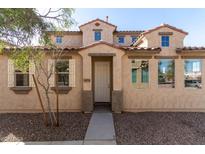 Charming two-story home featuring a beautiful stucco exterior, arched entry and well-manicured landscaping at 5474 W Fulton St, Phoenix, AZ 85043