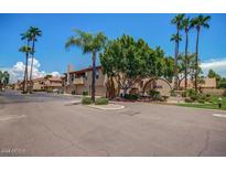 Exterior street view of residences with desert landscaping and palm trees on a sunny day at 5640 E Bell Rd # 1081, Scottsdale, AZ 85254