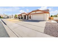 Charming single-story home featuring a well-maintained yard, tile roof, and an attached two-car garage at 5951 E Inglewood St, Mesa, AZ 85205