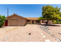 Charming single-story home with a well-maintained front yard, stone accents, and attached garage at 8538 E Vista Dr, Scottsdale, AZ 85250