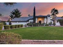 Beautiful single-Gathering home featuring a well-manicured lawn, mature landscaping, and a three car garage at 9921 E Doubletree Ranch Rd, Scottsdale, AZ 85258