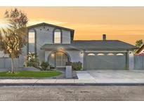 Charming two-story home featuring stucco exterior, arched entryway, and a well-manicured front yard at 10252 N 46Th Dr, Glendale, AZ 85302