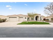 Charming home featuring a two-car garage, arched entryway, and well-maintained desert landscaping at 11232 E Palomino Rd, Scottsdale, AZ 85259