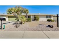 Charming single-story home with low-maintenance desert landscaping and a two-car garage at 12806 W Galaxy Dr, Sun City West, AZ 85375