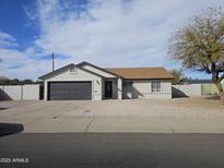 Charming single-story home features a low maintenance yard and gray garage door at 1511 N Kadota Ave, Casa Grande, AZ 85122