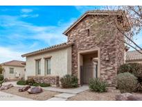 Charming single-story home with stone accents and a well-manicured front yard at 17359 W Grant St, Goodyear, AZ 85338