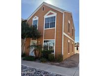 Two story home featuring brown wood siding, white trim, and manicured landscaping at 1970 N Hartford St # 11, Chandler, AZ 85225