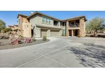 Attractive multi-level townhome with dual garage, desert landscaping, and stucco and stone exterior finishes at 2425 W Bronco Butte Trl # 2008, Phoenix, AZ 85085