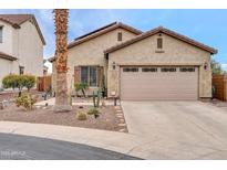 Charming single-story home featuring a two-car garage and drought-tolerant landscaping at 26065 W Yukon Dr, Buckeye, AZ 85396
