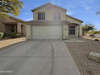 Charming two-story home with neutral tones, a spacious driveway, and low maintenance desert landscaping at 4603 E Laredo Ln, Cave Creek, AZ 85331