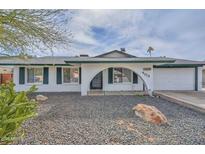 Charming single-story home featuring white brick, dark green trim, and a low-maintenance desert landscape at 4713 W Carol Ave, Glendale, AZ 85302