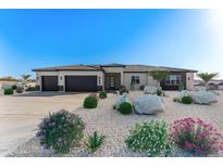 Charming single-story home with desert landscaping, three-car garage, and a neutral color scheme at 7259 S 221St Ave, Buckeye, AZ 85326