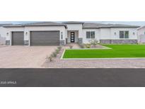 Charming single Gathering home with a two car garage, easy to maintain lawn, and neutral tones at 7295 S 221St Ave, Buckeye, AZ 85326