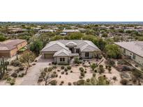 Stunning aerial view of custom home with desert landscaping and charming courtyard entry at 7829 E Softwind Dr, Scottsdale, AZ 85255