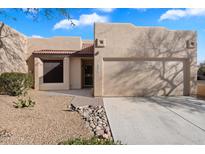 Inviting single-story home with a two-car garage, desert landscaping, and a charming front entry at 10815 N 117Th Pl, Scottsdale, AZ 85259