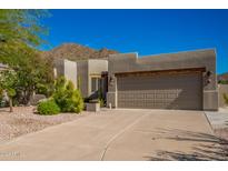 Contemporary home with a two-car garage and desert landscaping at 11919 N 138Th St, Scottsdale, AZ 85259