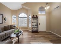 Inviting living room featuring ample natural light, wood floors, and neutral tones at 12926 W Pershing St, El Mirage, AZ 85335