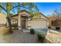 Charming single-story home with desert landscaping, covered entry and two-car garage at 12947 W Mauna Loa Ln, El Mirage, AZ 85335