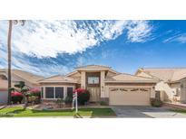 Charming single-story home with a well-manicured lawn, desert landscaping, and a two-car garage at 15644 S 13Th Pl, Phoenix, AZ 85048