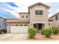 Two-story home with a well-maintained front yard and a two-car garage at 19075 E Pelican Dr, Queen Creek, AZ 85142