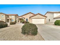 Charming single-story home with a well-manicured desert landscape and a two-car garage at 2210 E Caspian Way, San Tan Valley, AZ 85140