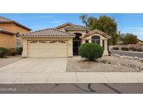 Charming single-story home featuring a tile roof, landscaped front yard, and a two-car garage at 2416 E Cielo Grande Ave, Phoenix, AZ 85024