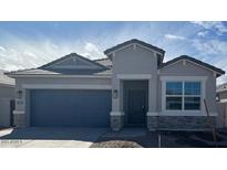 Charming single-story home featuring a two-car garage, neutral stucco, and stone accents at 25401 W Sunland Ave, Buckeye, AZ 85326