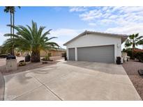 A well-kept home featuring a spacious three-car garage and meticulously maintained desert landscaping at 2568 N Armour Ave, Mesa, AZ 85215