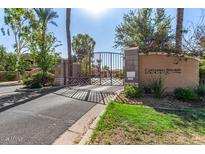 Cantabria Shores gated community entrance featuring lush landscaping and secure access at 3800 S Cantabria Cir # 1013, Chandler, AZ 85248