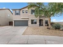 Charming two-story home with neutral stucco and gray accents, and a well maintained yard at 4473 E Whitehall Dr, San Tan Valley, AZ 85140