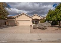 Charming single-story home with a desert landscaped front yard and a three car garage at 4552 E Chuckwalla Cyn, Phoenix, AZ 85044