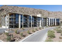 Modern condo building with balconies and desert landscaping nestled at the base of a mountain at 5000 N Camelback Ridge Rd # 210, Scottsdale, AZ 85251