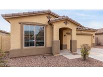 Charming single-story home featuring a tile roof, stucco siding, and a well-manicured gravel front yard at 7221 W Wood St, Phoenix, AZ 85043