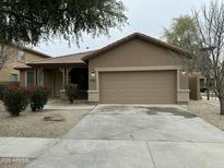 Charming single-Gathering home featuring a two-car garage and landscaped front yard at 9017 W Kirby Ave, Tolleson, AZ 85353