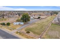 Expansive ranch property featuring a single-story home and large fenced pastures, offering rural living close to town at 97 W Marilyn Way, San Tan Valley, AZ 85140