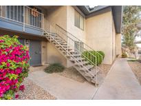 Inviting exterior of a two-story apartment building with well-maintained landscaping and decorative railings at 1402 E Guadalupe Rd # 145, Tempe, AZ 85283