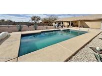 The sparkling pool is the focal point of this backyard retreat, ready for you to enjoy on sunny days at 14545 S Cherry Hills Dr, Arizona City, AZ 85123