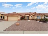 Charming home featuring a two-car garage, front yard desert landscaping, and a welcoming front entrance at 15924 W Falcon Ridge Dr, Sun City West, AZ 85375