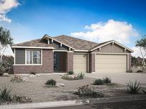 Charming single-story home with brick and siding, desert landscaping, and a two-car garage at 18432 W Mohave St, Goodyear, AZ 85338