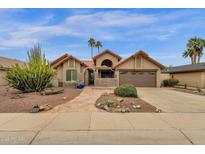 Charming single-story home featuring desert landscaping, a two-car garage, and a welcoming front entry at 1975 E Sunburst Ln, Tempe, AZ 85284