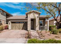 Charming single-story home featuring a stone facade, brick driveway, and well-maintained landscaping at 20524 W Nelson Pl, Buckeye, AZ 85396