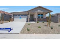 Charming single-story home with neutral tones, a two car garage and rock landscaping at 24192 W Agora Ln, Buckeye, AZ 85326
