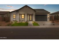 Beautiful single Gathering home featuring a well manicured yard and a two car garage at 34283 N Sandpiper Trl, Queen Creek, AZ 85144