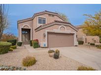 Charming two-story home with a two car garage, manicured front yard with desert landscaping, and a neutral color palette at 4228 E Desert Sky Ct, Cave Creek, AZ 85331