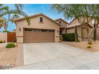 Charming single-Gathering home showcasing desert landscaping with cacti, gravel, and a mature tree at 5948 W Leiber Pl, Glendale, AZ 85310