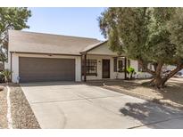 Well-maintained one-story home boasting a two-car garage and desert landscaping at 6427 E Grandview Dr, Scottsdale, AZ 85254