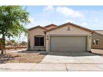 Charming single-story home features a well-manicured yard and attached two-car garage at 7147 S Morning Dew Ln, Buckeye, AZ 85326