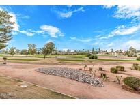 Expansive view of the meticulously maintained golf course with lush green grass and mature trees under a partly cloudy blue sky at 7428 N Via Camello Del Norte -- # 182, Scottsdale, AZ 85258